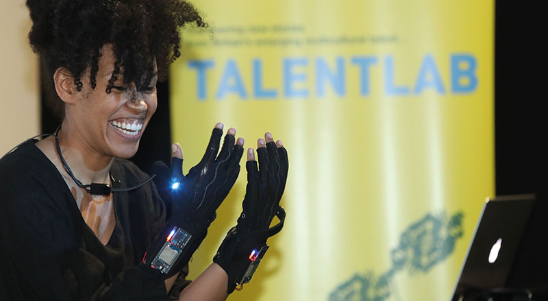 Woman wearing tech gloves at Talentlab Credit B3 Media, 2017