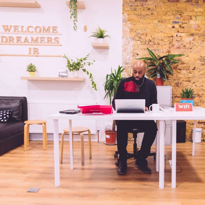 A black male sitting at a desk working