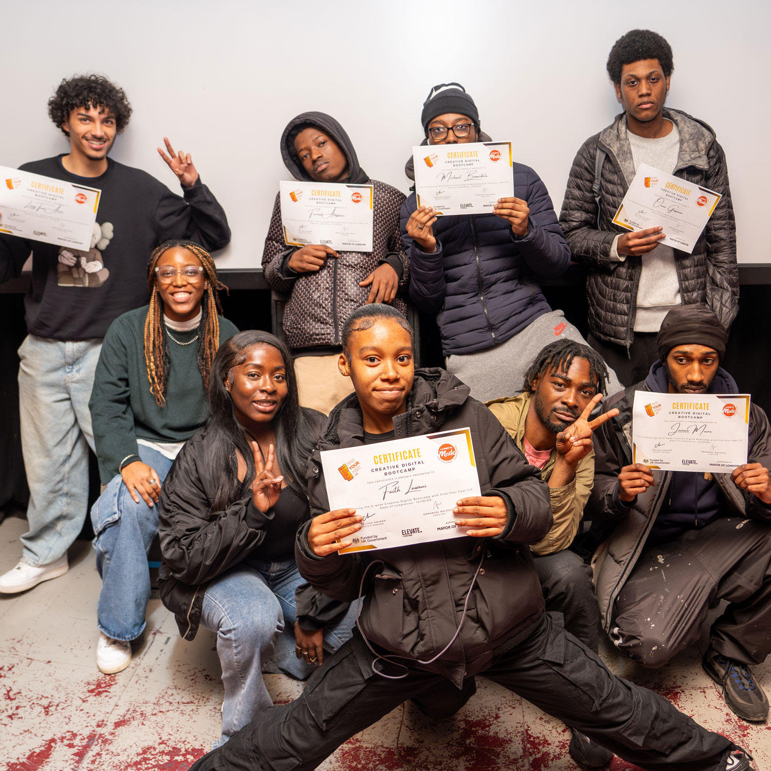 YOung people showing their certificates at one of the creative bootcamps