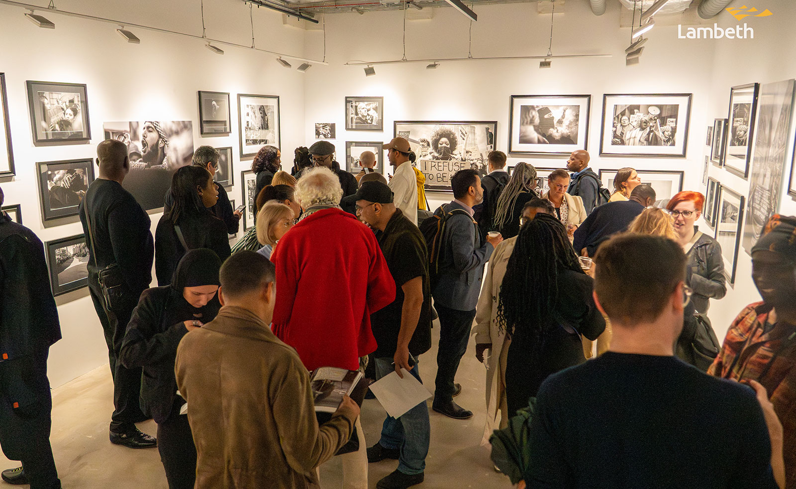 Image showing people attending the ‘From George to Gaza, A Retrospective by Wayne Campbell’ private view event at Photofusion