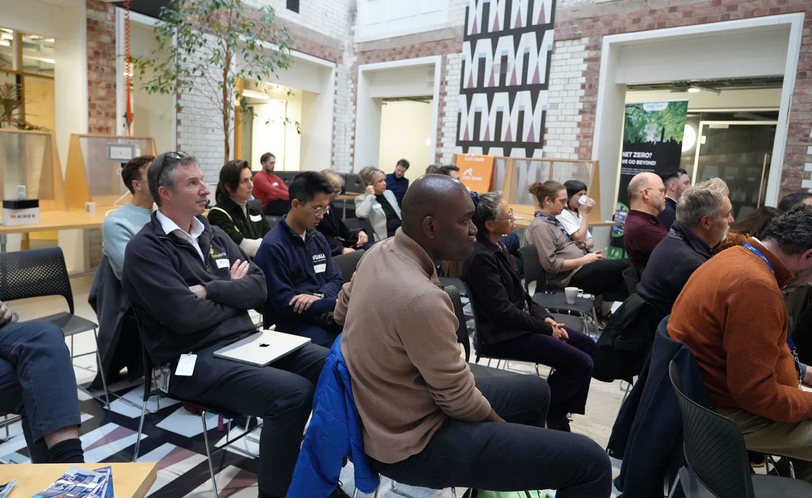 The audience at the Pitch Day event sit in rows watching the speeches and pitches.