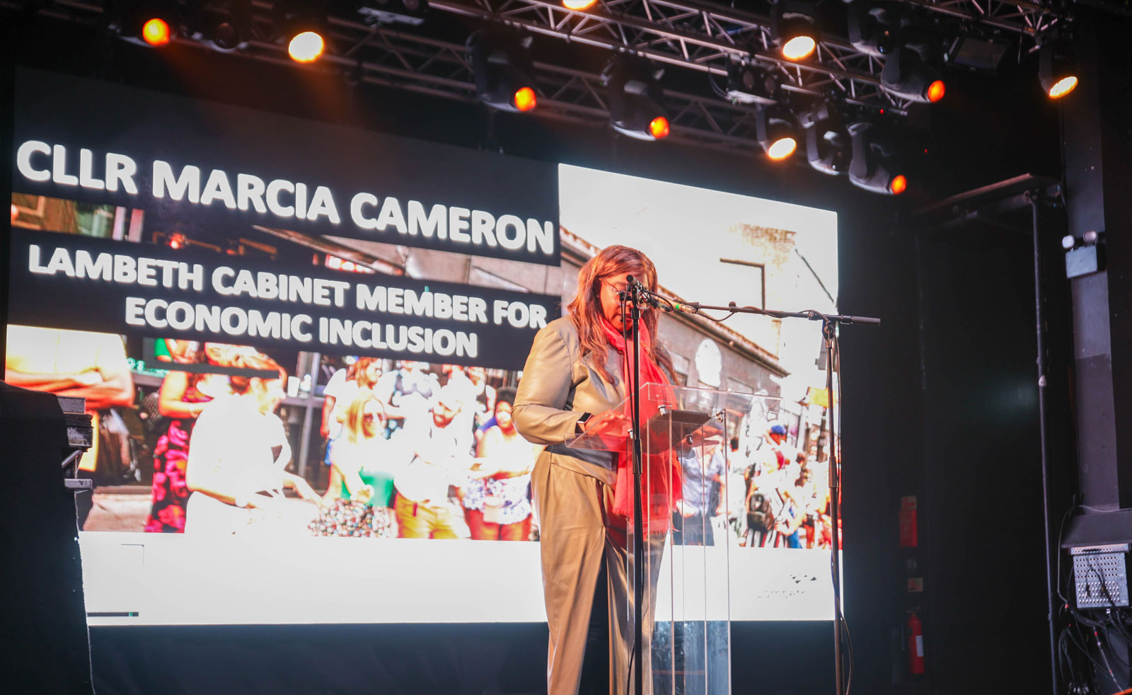 Lambeth's Cabinet Member for Economic Inclusion, Councillor Marcia Cameron, speaking into a mic at a lectern