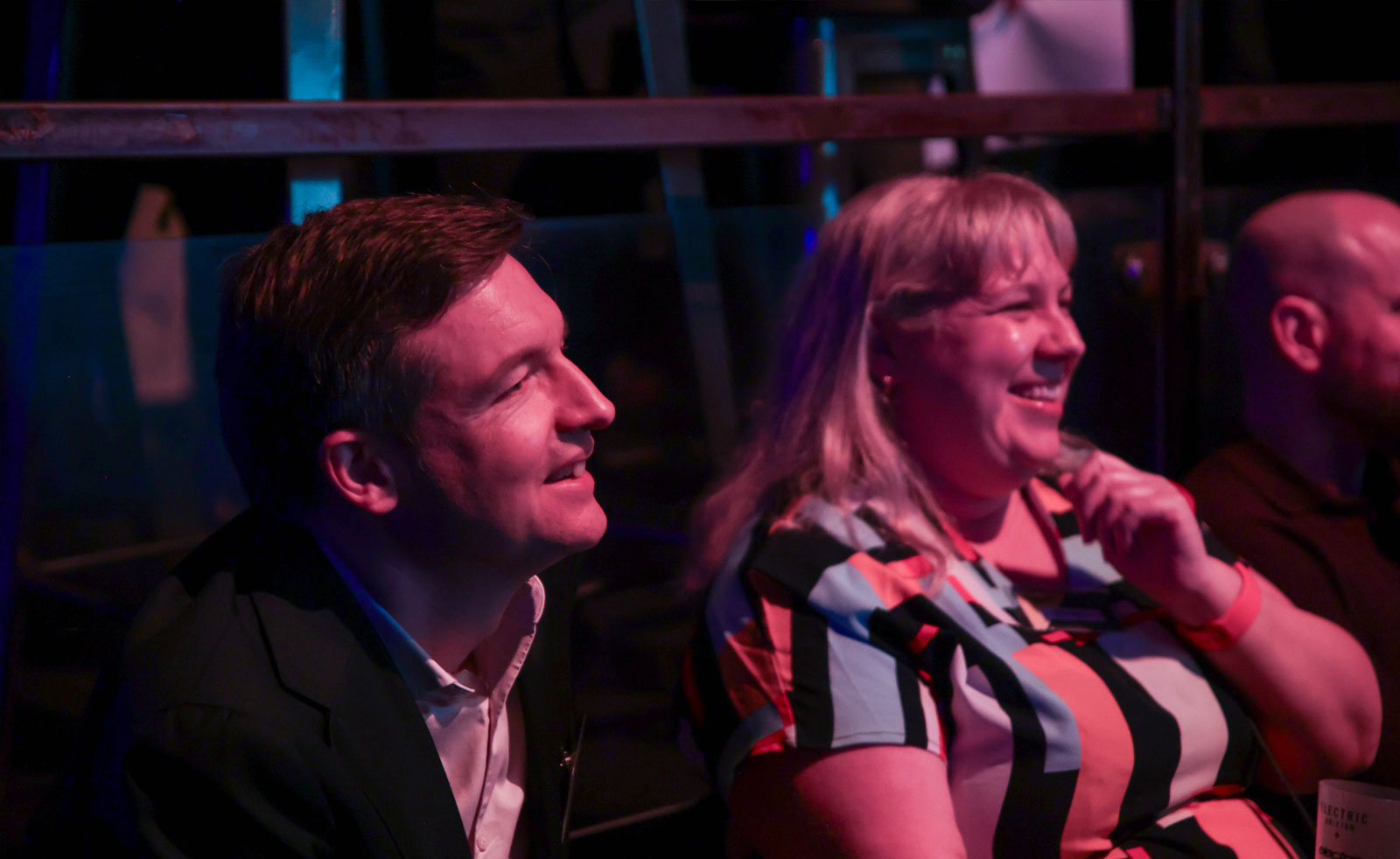 Two audience members laughing
