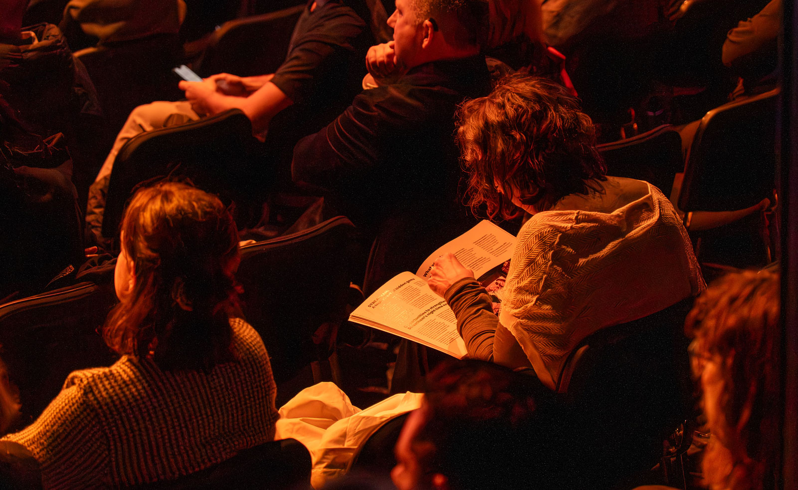 A view of people sitting down and looking through a document