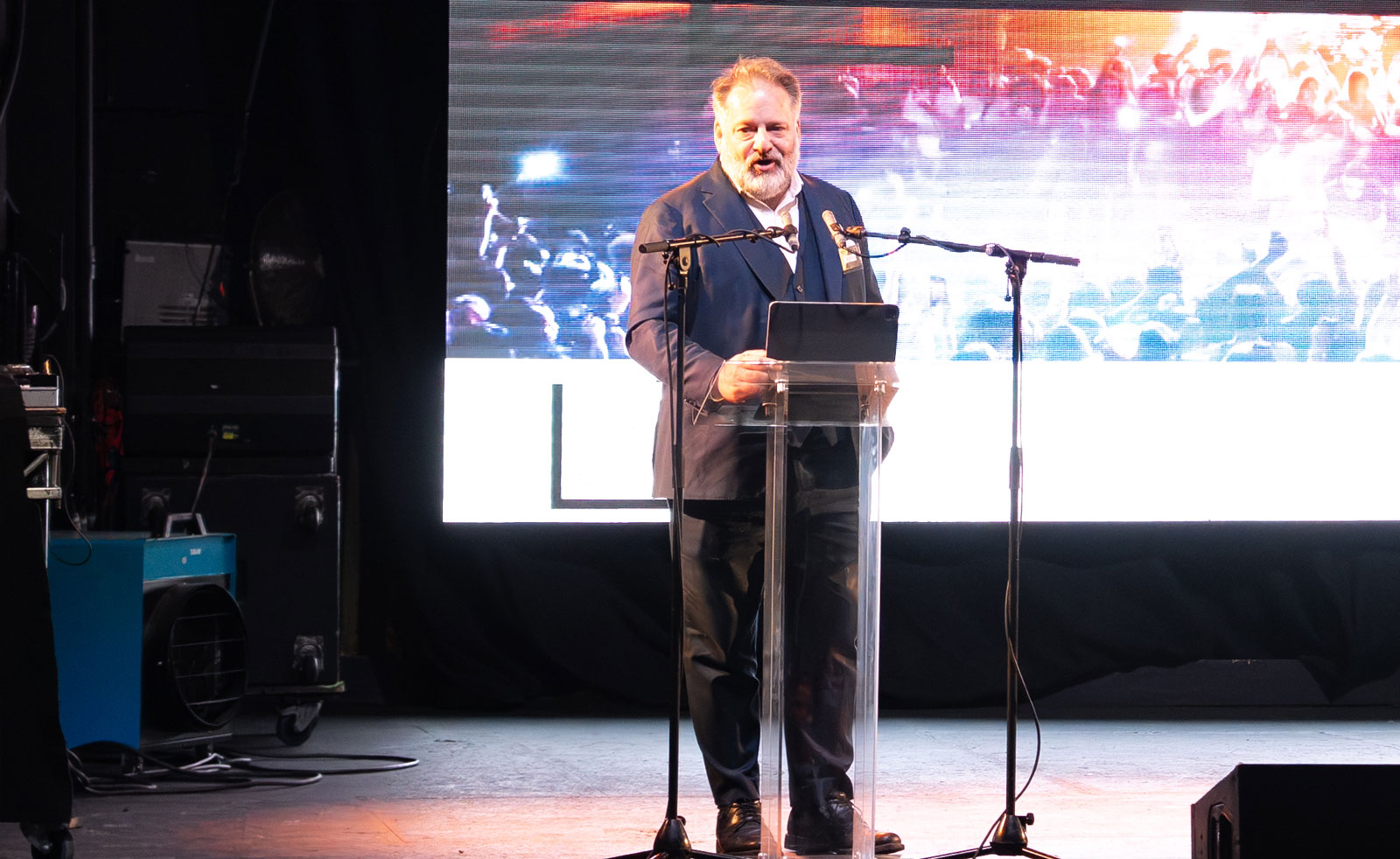 London's Deputy Mayor for Business, Howard Dawber, speaking into a mic at a lectern