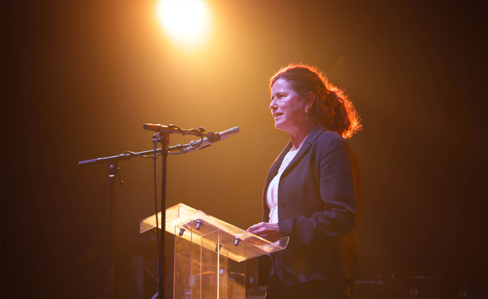 A photo of Lambeth's Leader, Councillor Claire Holland, speaking into a mic at a lectern