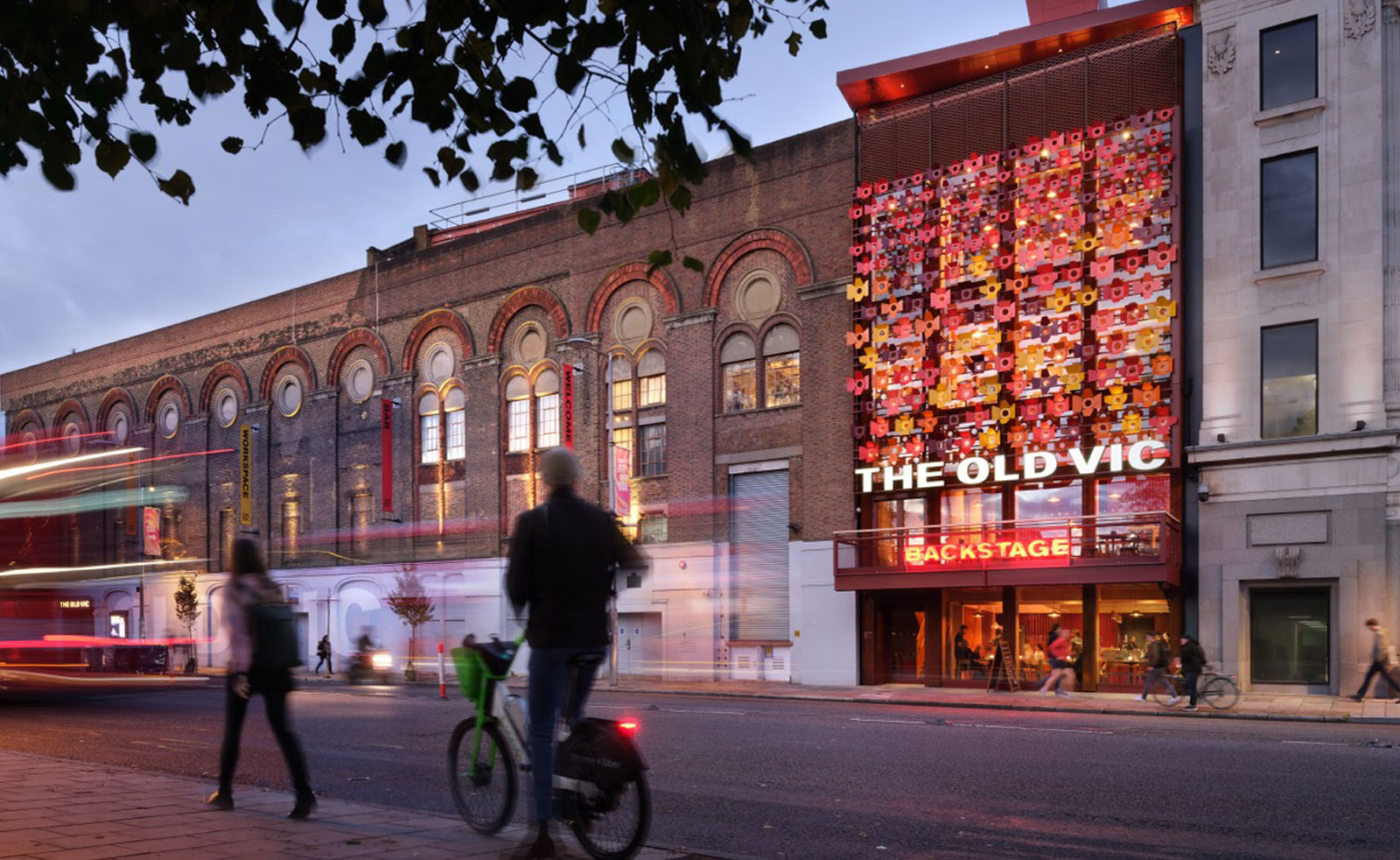 Oustide of the new old vic backstage building with a cyclist in the foreground