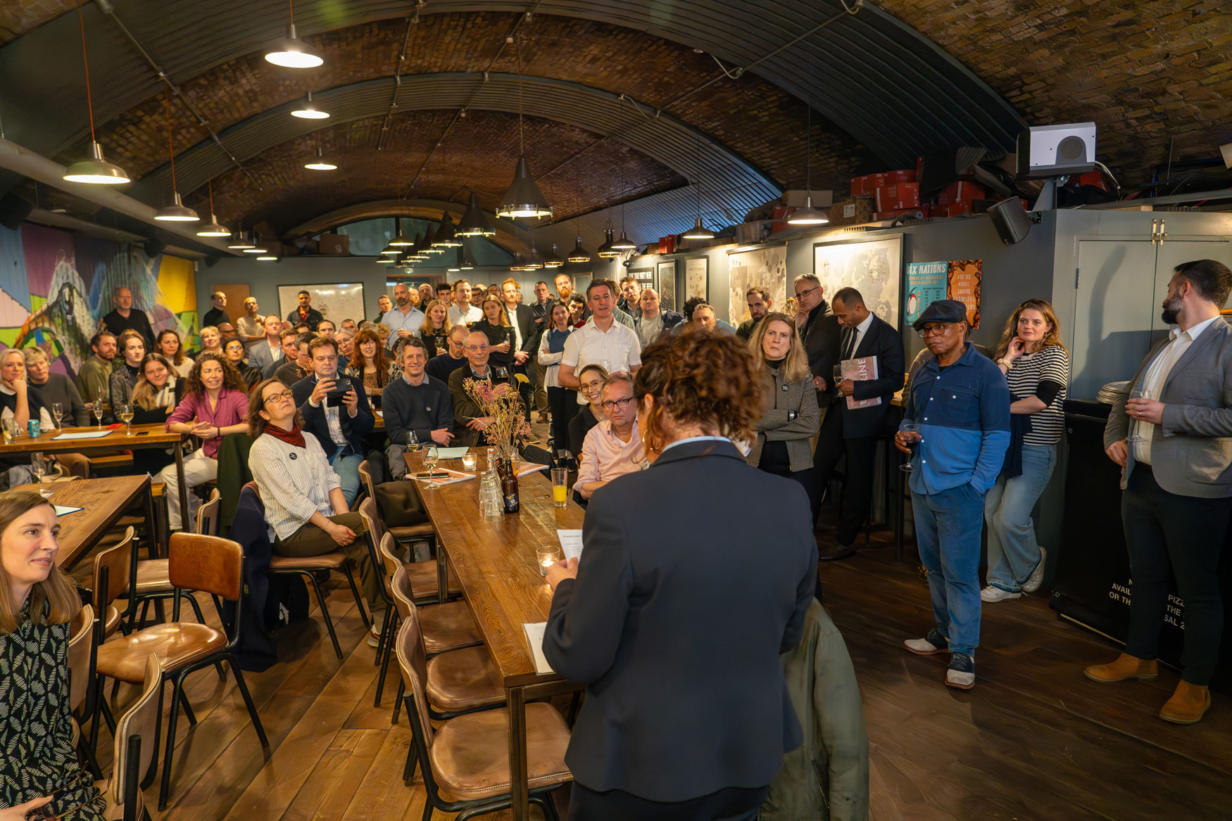 Lambeth's Leader, Councillor Claire Holland speaking to a mix of seated and standing people in a bar restaurant space