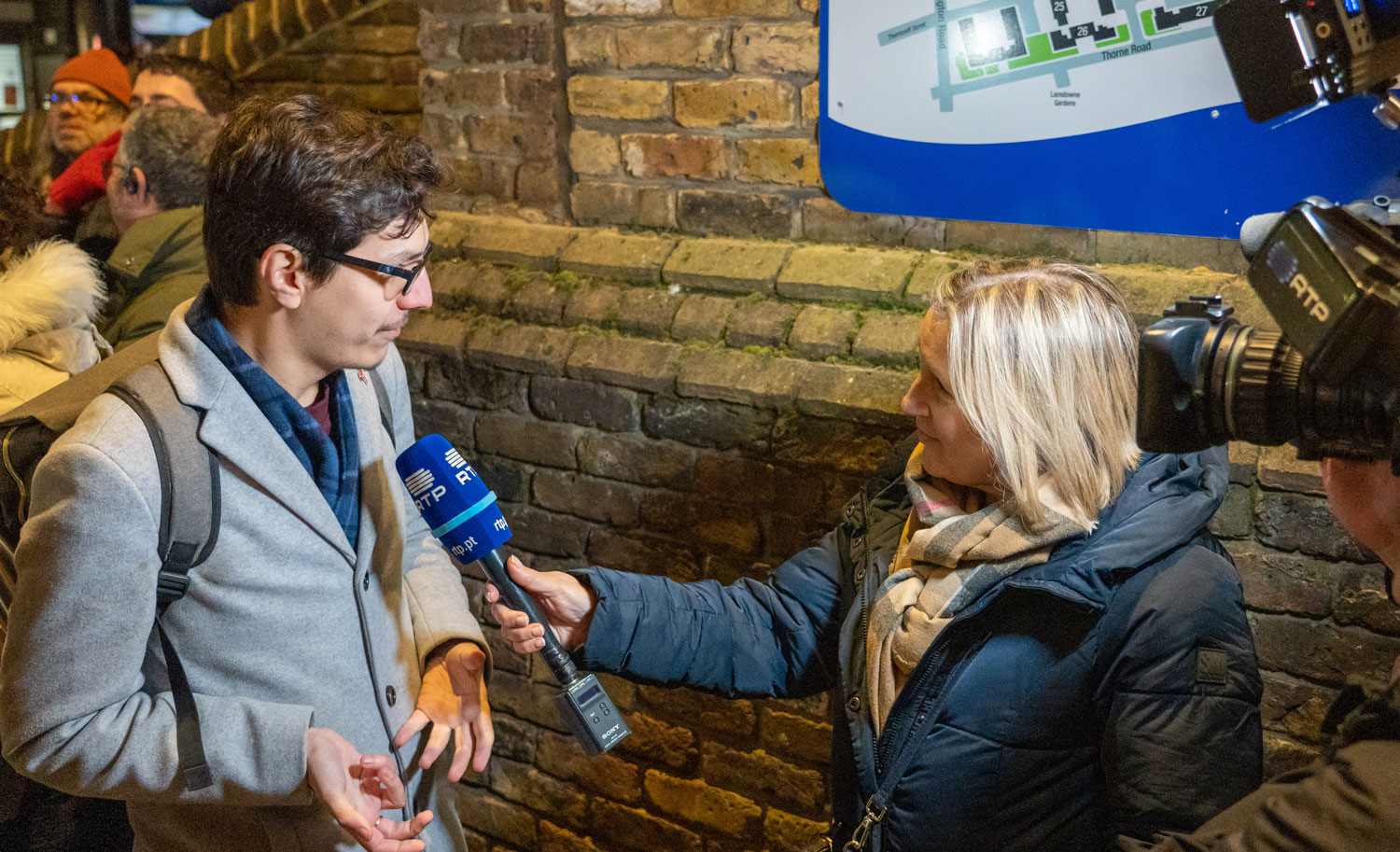 Lambeth Councillor Diogo Costa speaking to Portuguese news media about the Portuguese-speaking communities mural on Wilcox Close