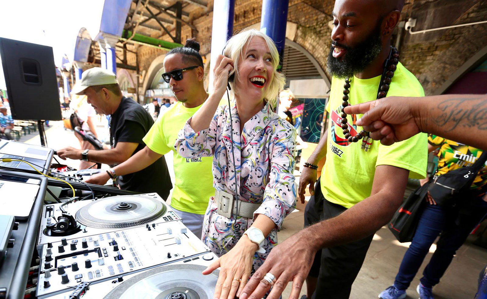 London's Deputy Mayor for Culture joins two DJs on some DJ decks set up outdoors in Brixton