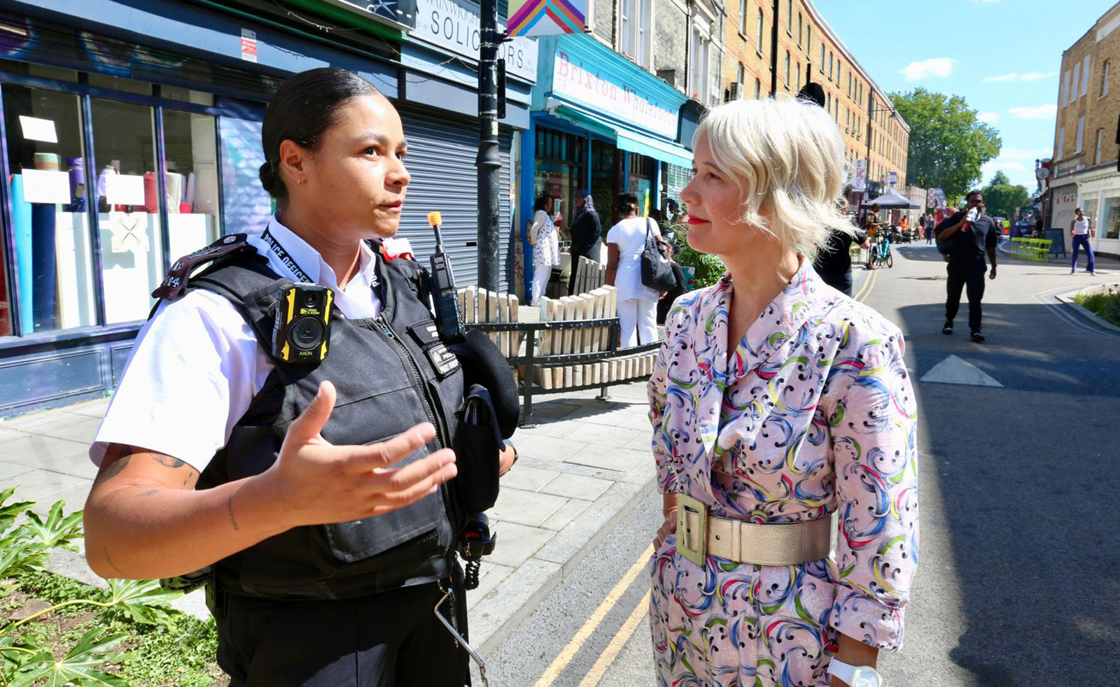 London's Deputy Mayor for Culture speaks with a local Met Police officer on Atlantic Road in Brixton