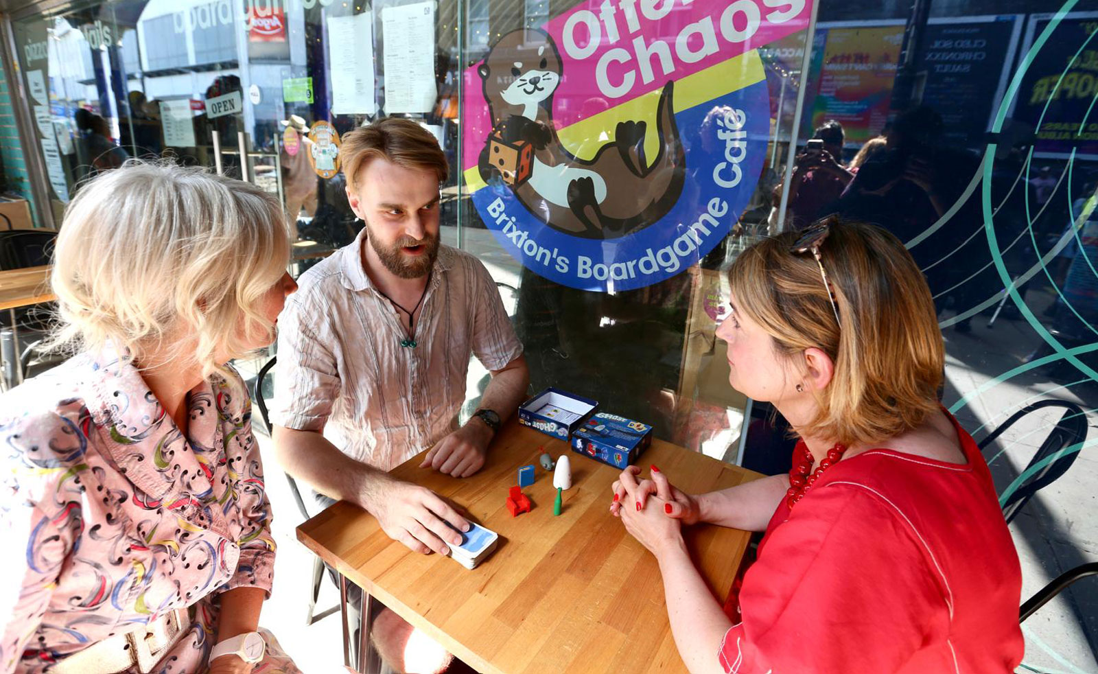 Brixton's MP and London's Deputy Mayor for Culture play board games outdoors with a local community member