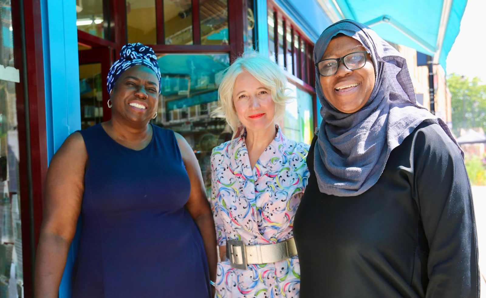 London's Deputy Mayor for Culture stands with local community members on Atlantic Road in Brixton, all are smiling for the camera