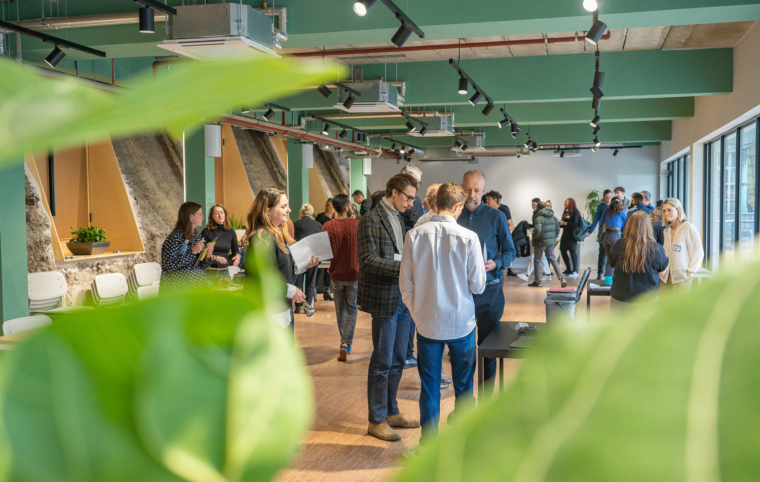 Image of event attendees standing and networking in the event space