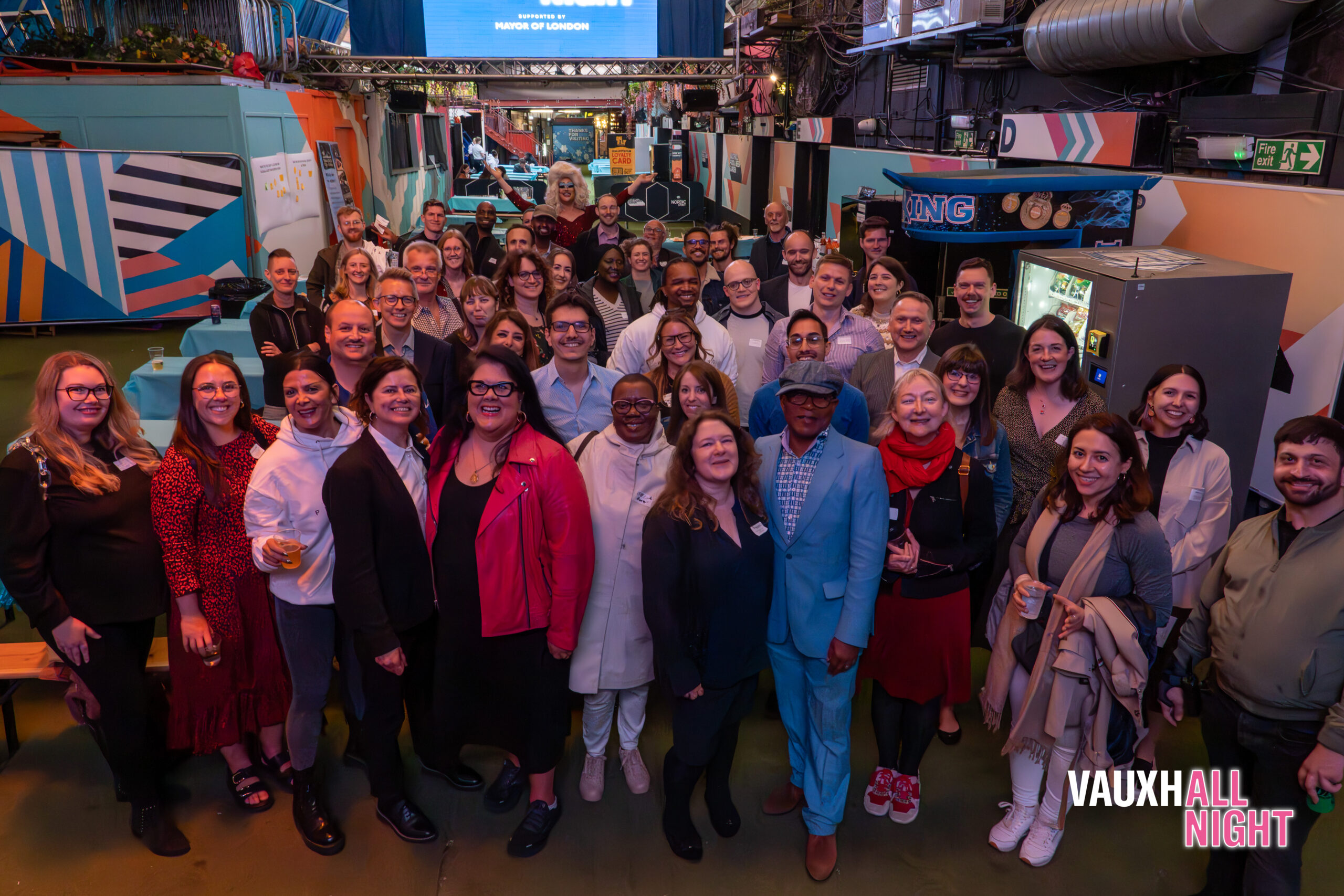 A large group of people standing and smiling for the camera in Vauxhall Food and Beer Garden