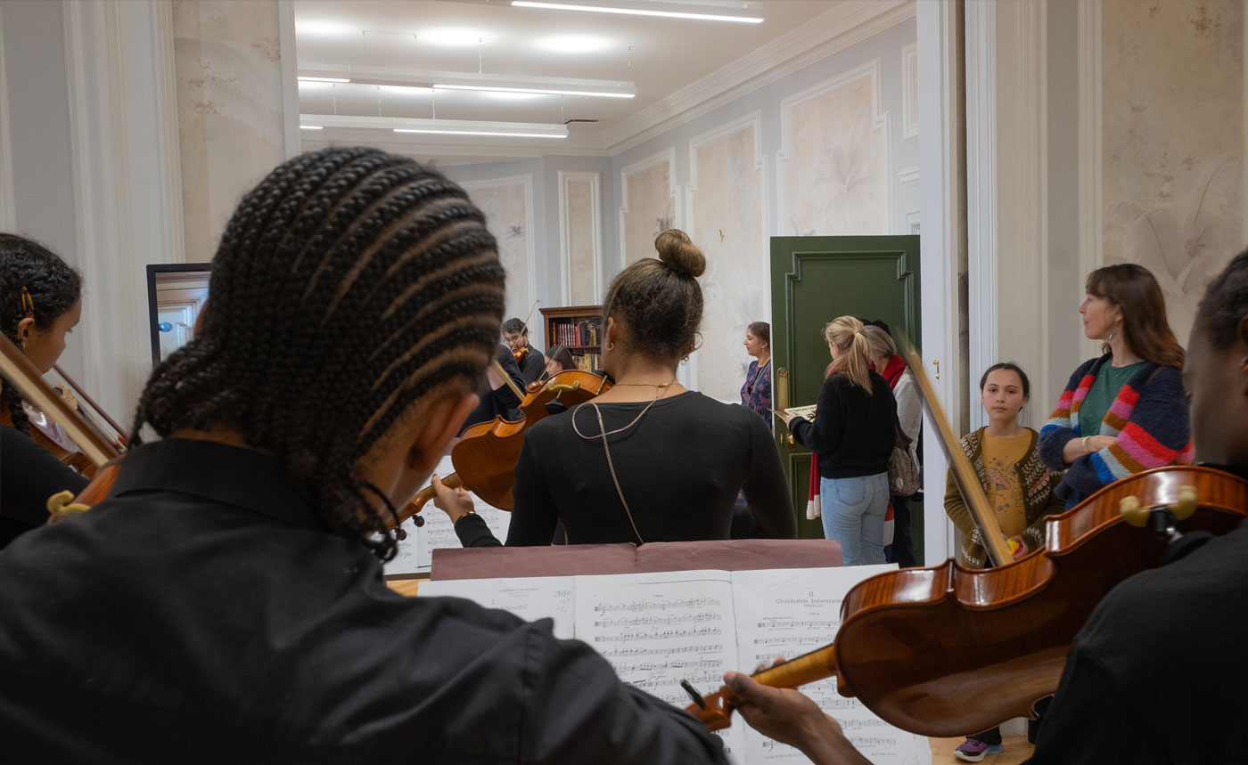 Young people playing instruments as people watch in Lambeth Townhall