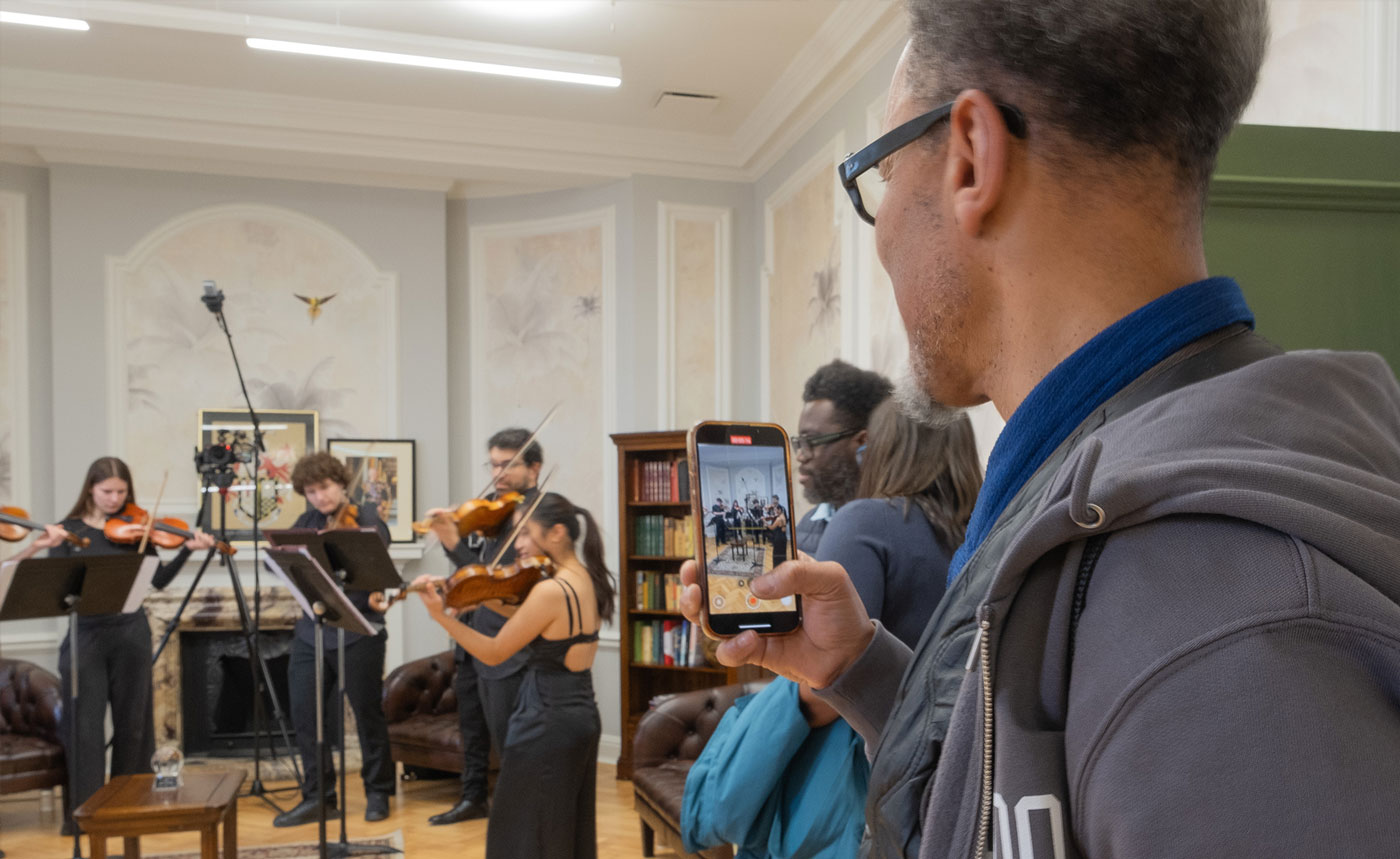 Young people playing instruments as people watch in Lambeth Townhall