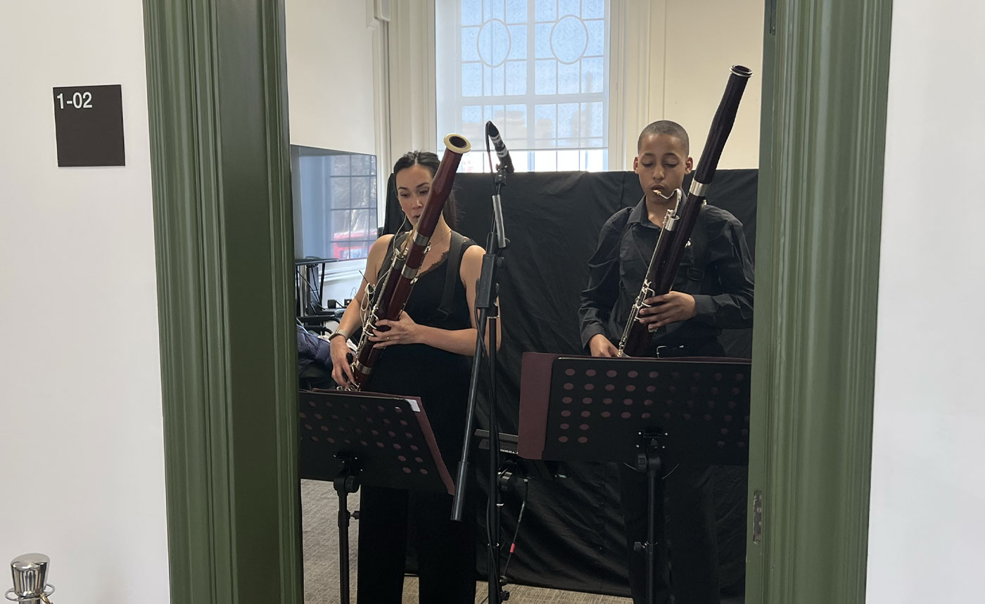 Two young people playing a bassoon in Lambeth's Townhall