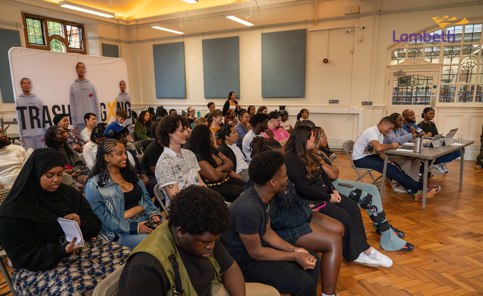 A picture of a group of young people watching a presentation