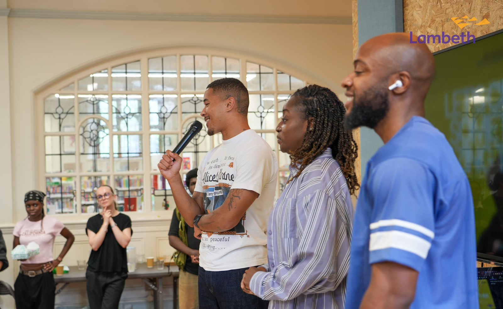 A picture of a person speaking with a mic