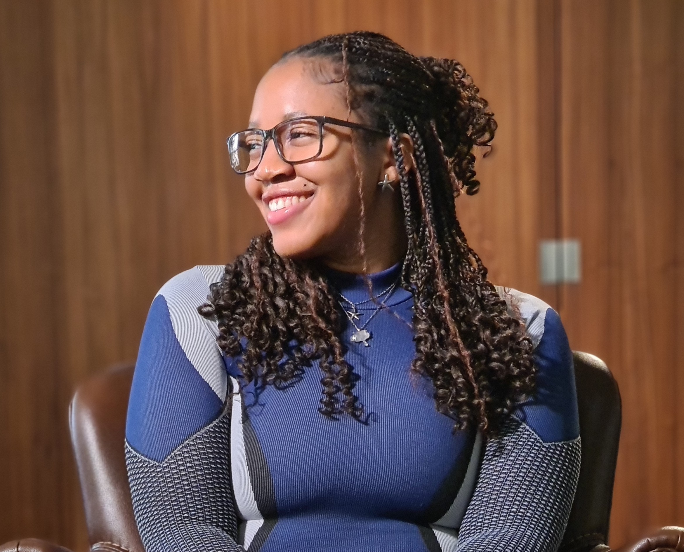 Elevator in chair smiling looking to the side