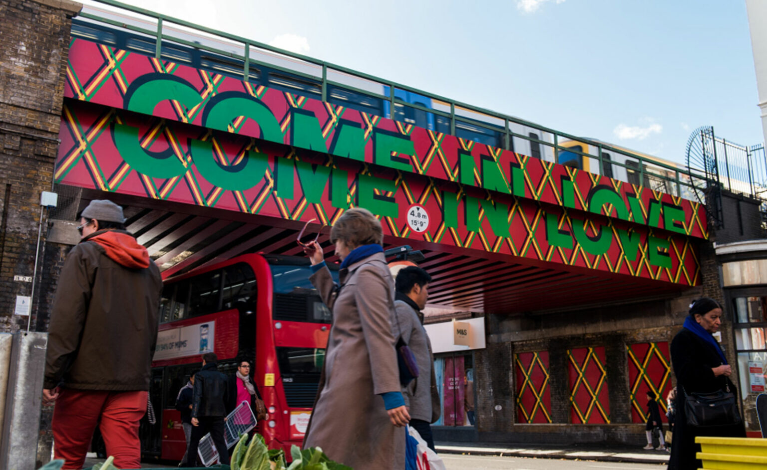 A member of the public walks past a bridge over Brixton Road