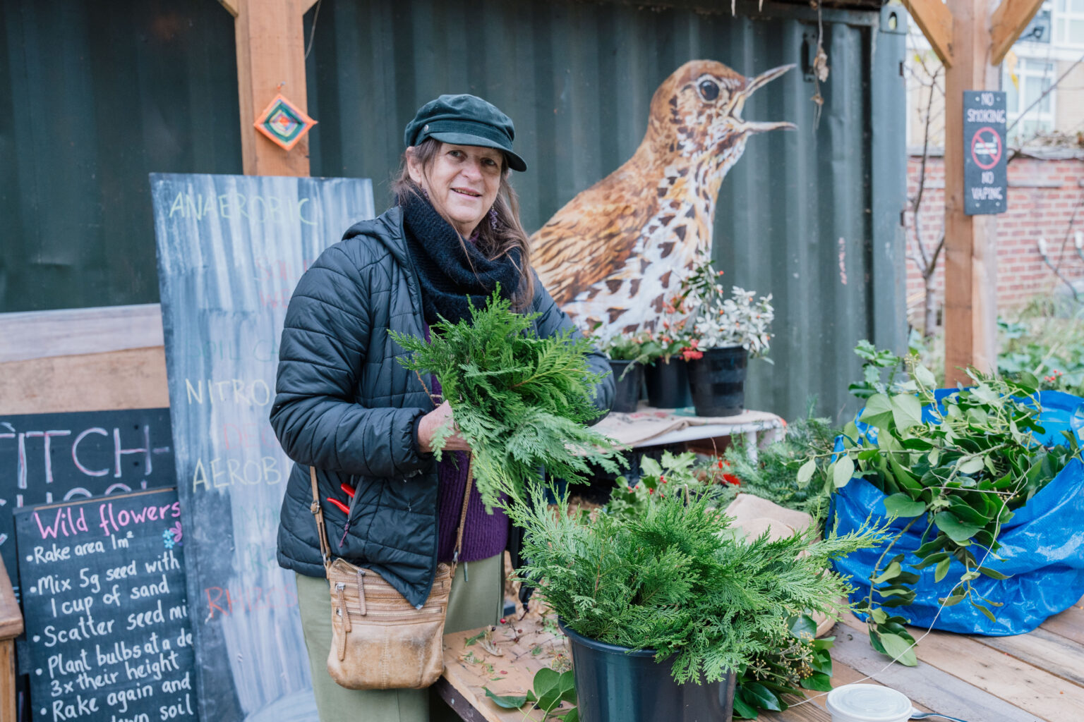 a photo of a Loughborough Farm garden volunteer posing next to plants