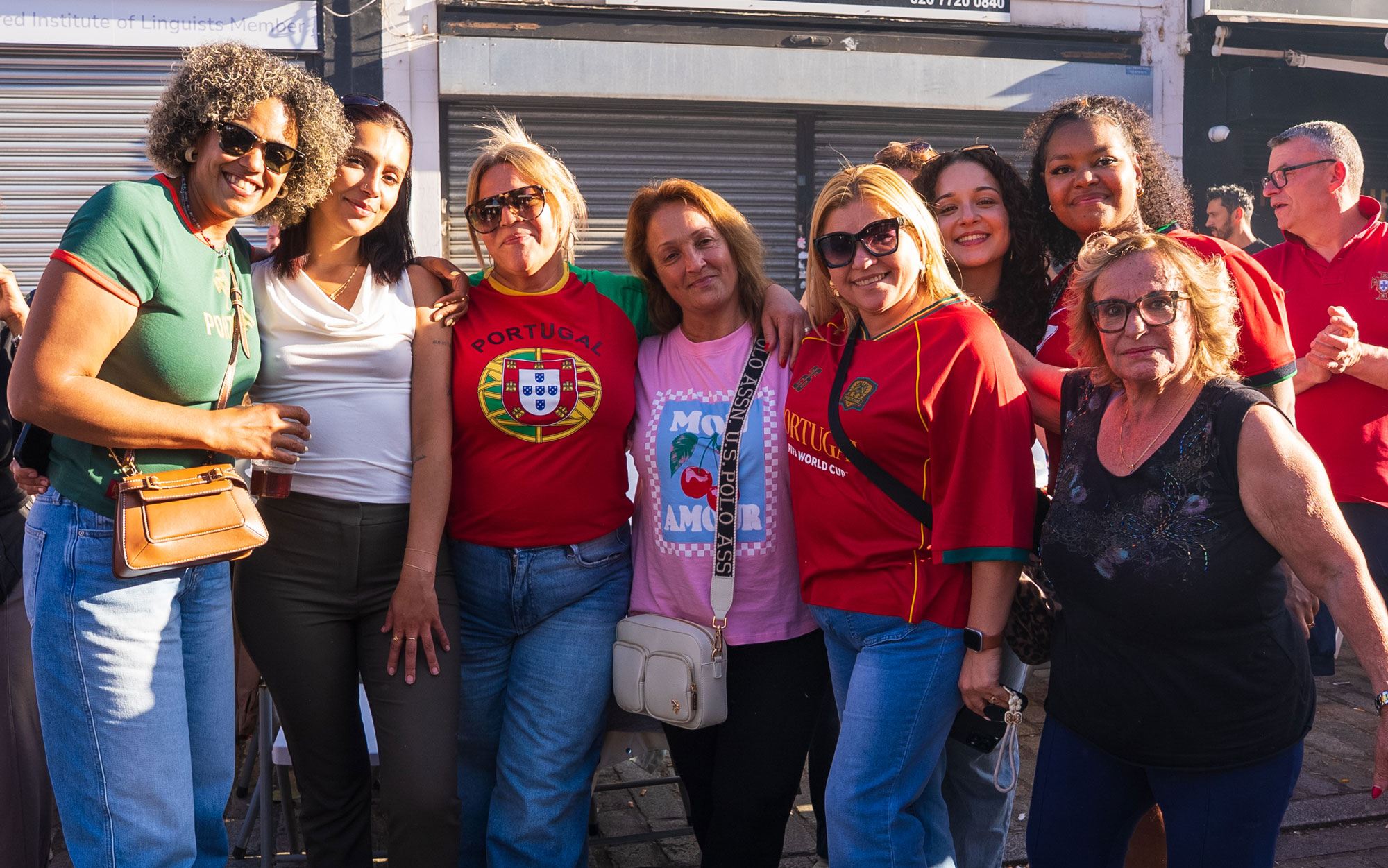 Group of festival attendees posing together and smiling for a photograph in Little Portugal.