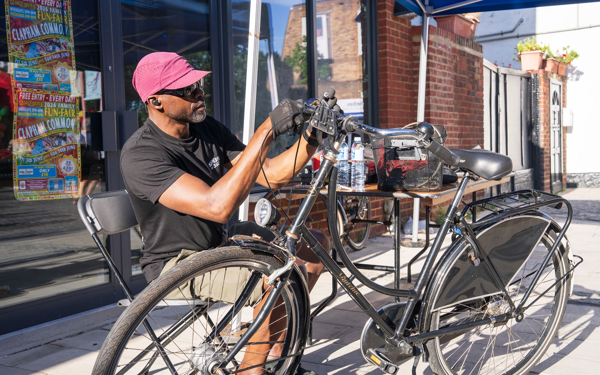 Volunteer carrying out repairs on a bicycle at a free bike maintenance stall during the festival.