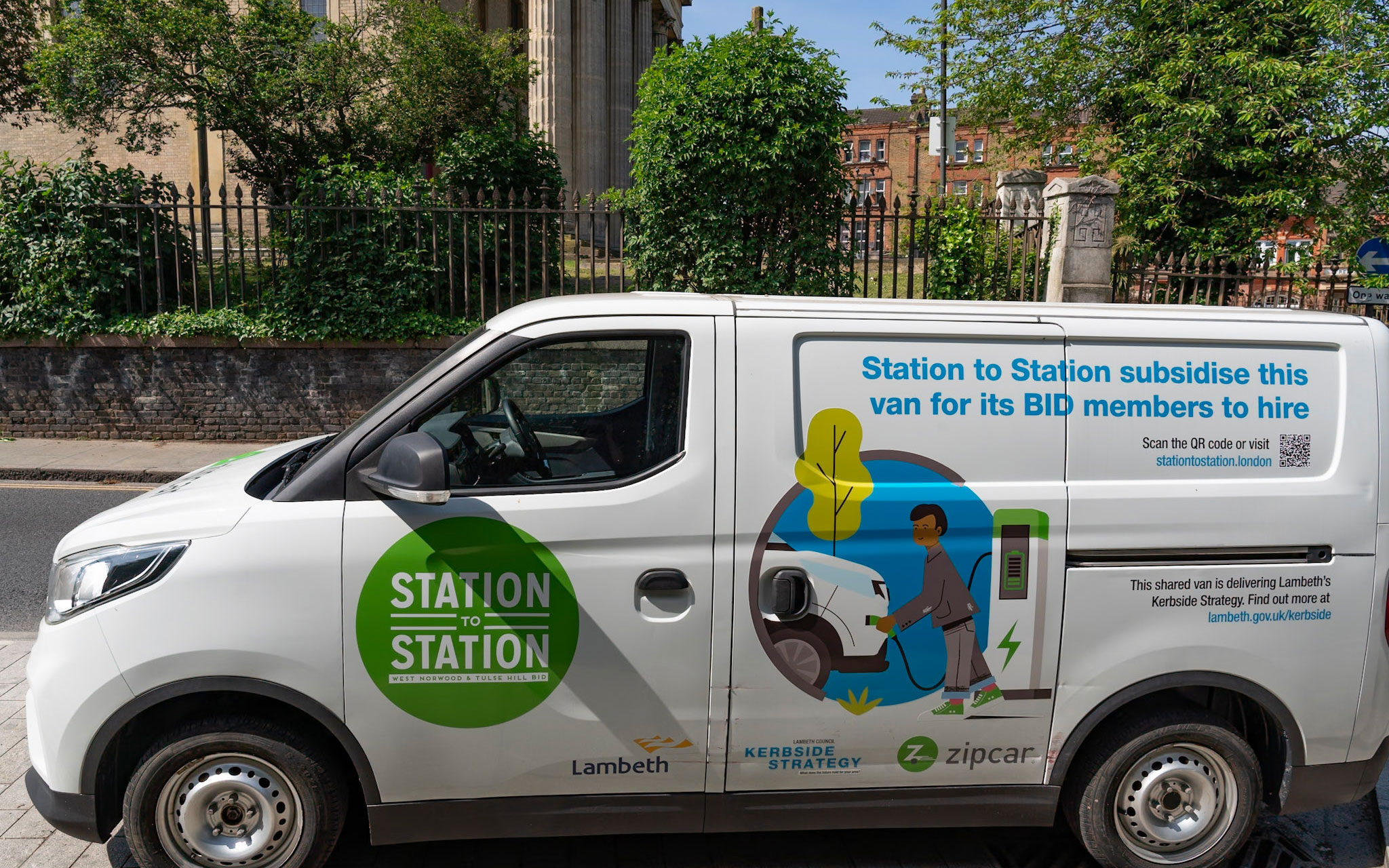 Electric van branded for the Station to Station BID and Lambeth Council's Kerbside Strategy, promoting a shared vehicle hire scheme for local businesses.