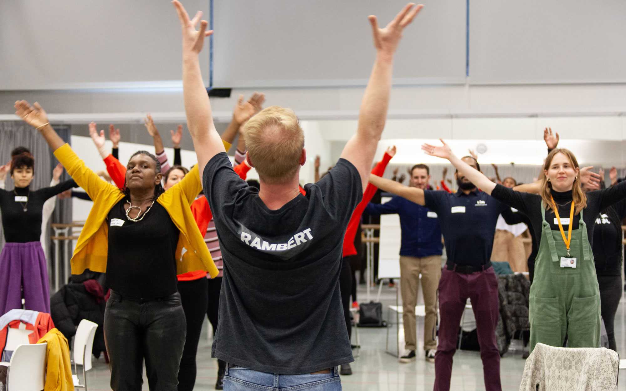future movement Participants raise their arms during a group movement workshop led by a Rambert facilitator.