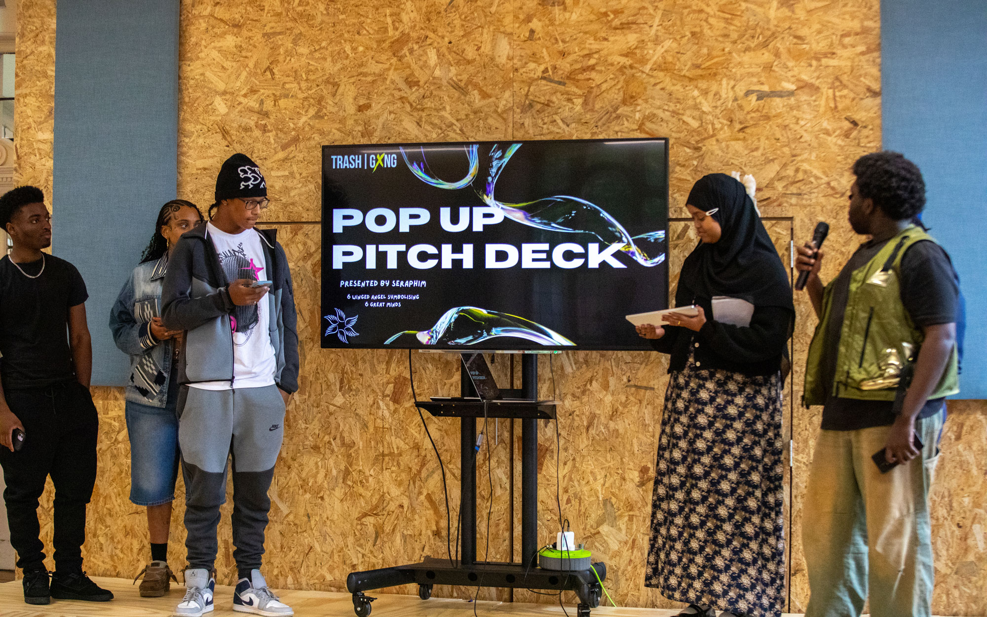 Young people deliver a pop-up pitch presentation at a Trash Gxng event.