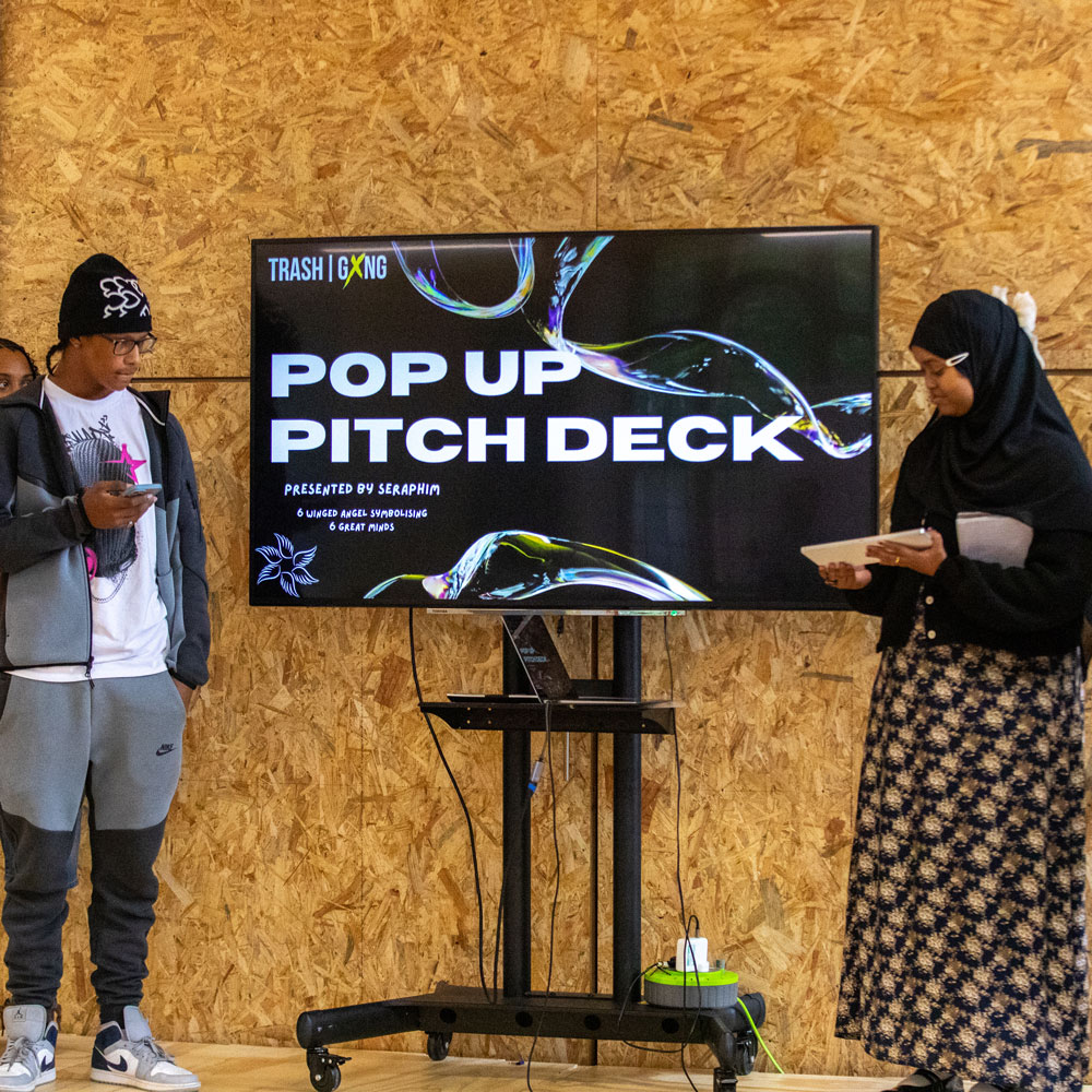 Young people deliver a pop-up pitch presentation at a Trash Gxng event.